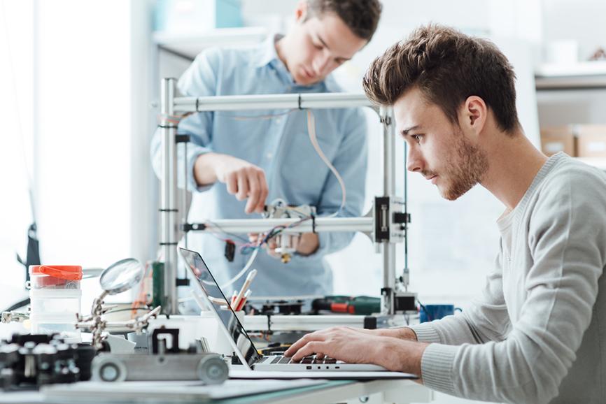 Futuristic Machine Engine Development Engineer Working On Computer At His  Desk Talks With Female Project Manager Team Of Professionals Working In The  Modern Industrial Design Institution Stock Photo - Download Image Now -